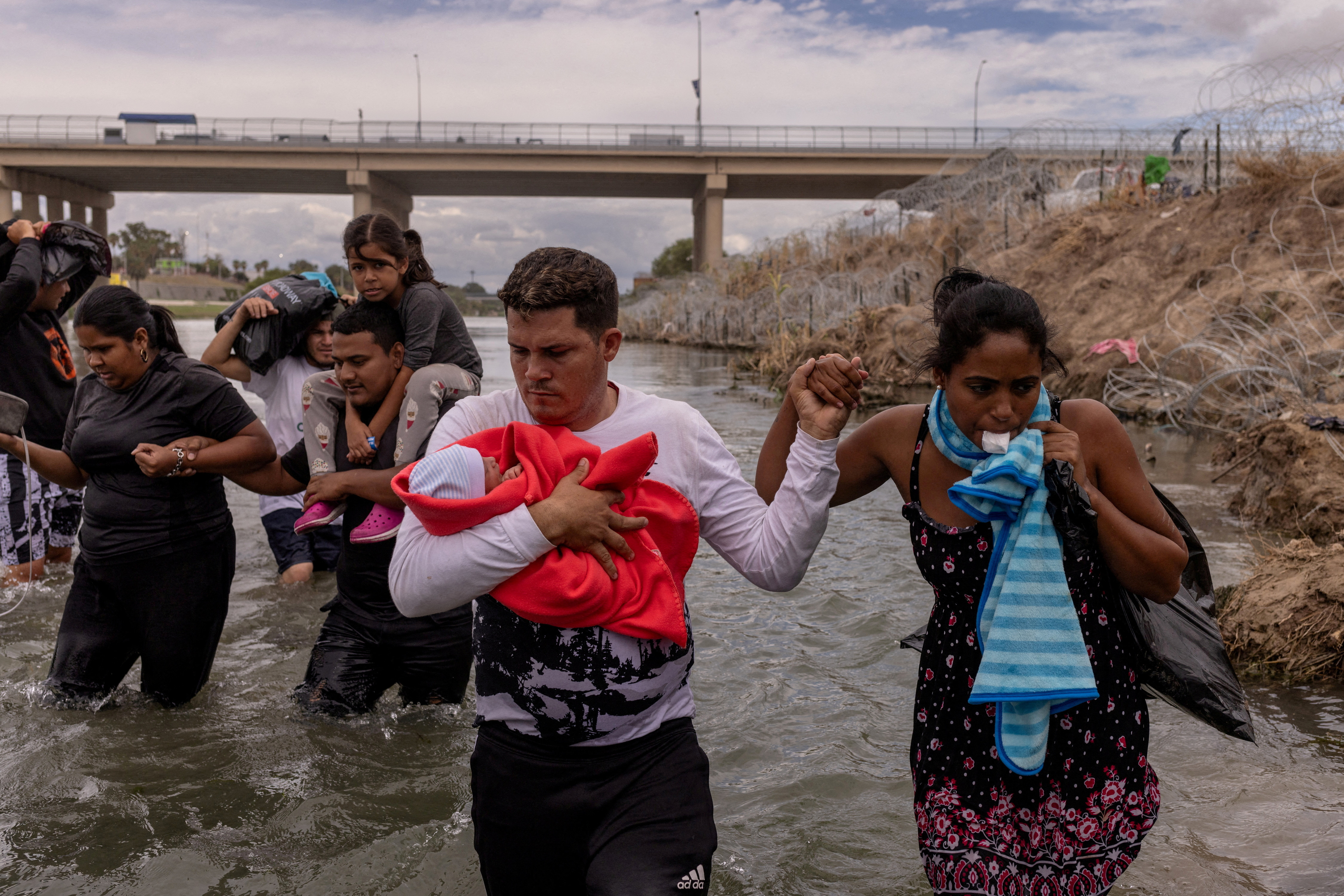 FILE PHOTO: Cuban migrants wade along bank of Rio Grande river in Eagle Pass