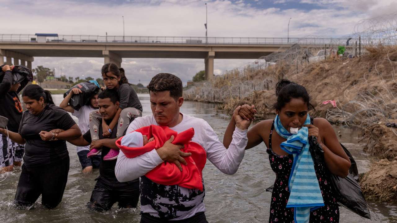 FILE PHOTO: Cuban migrants wade along bank of Rio Grande river in Eagle Pass