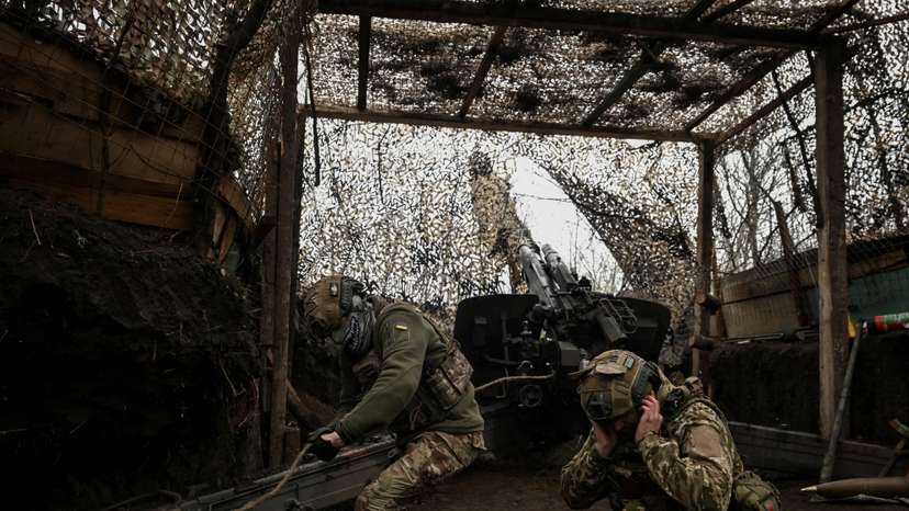 Ukrainian servicemen fire a howitzer towards Russian troops near the frontline town of Pokrovsk