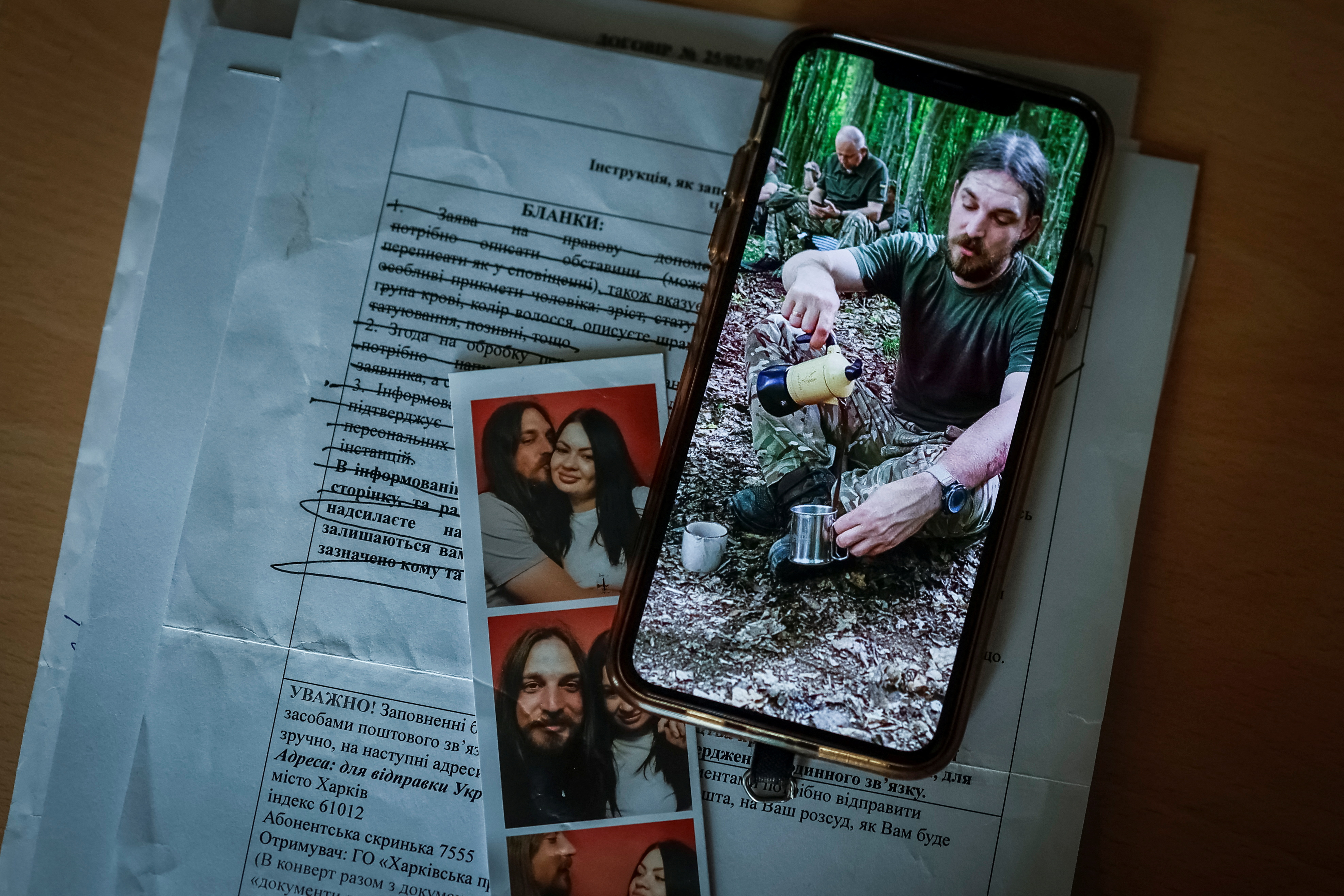 Photo of Ukrainian serviceman, who was declared missing-in-action in Donetsk region, is displayed on a phone of his wife, in Kyiv