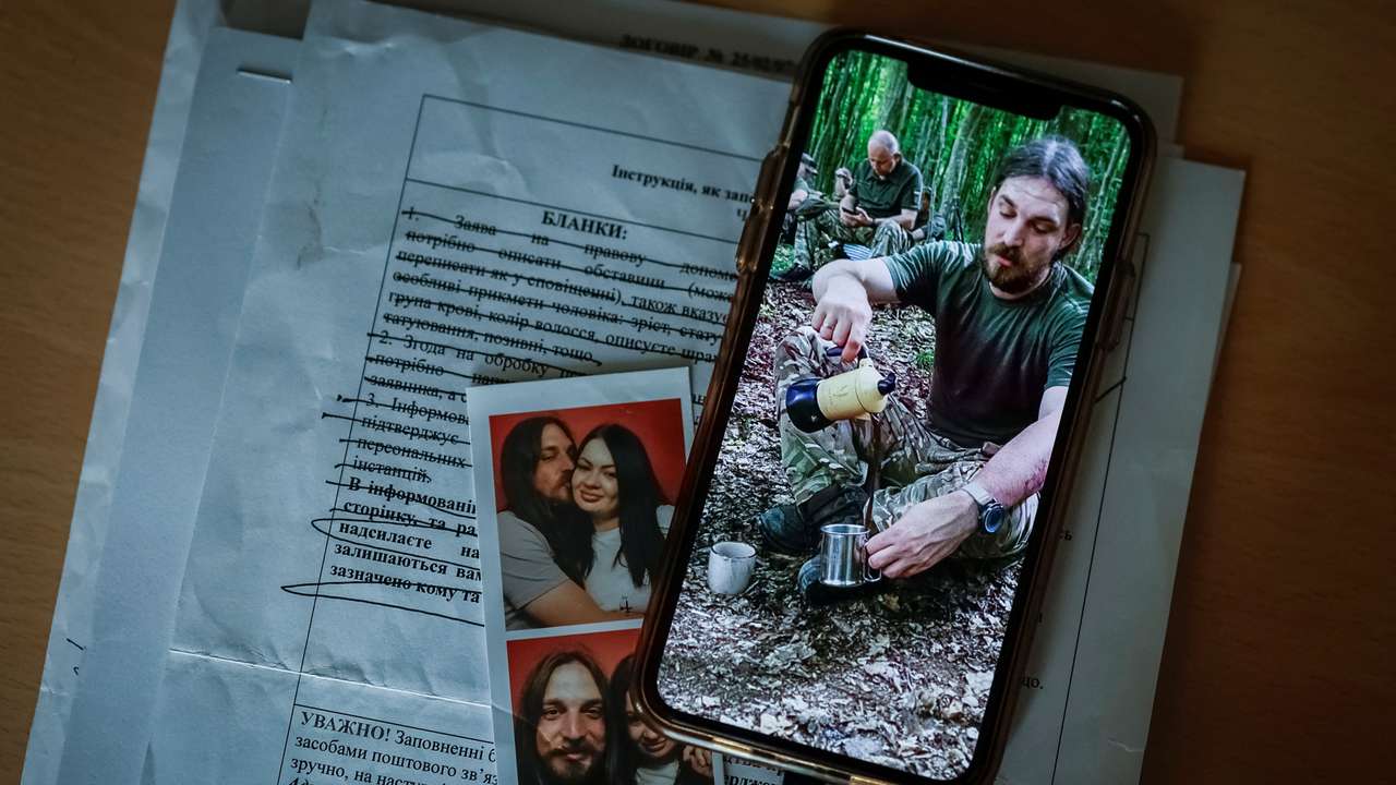 Photo of Ukrainian serviceman, who was declared missing-in-action in Donetsk region, is displayed on a phone of his wife, in Kyiv