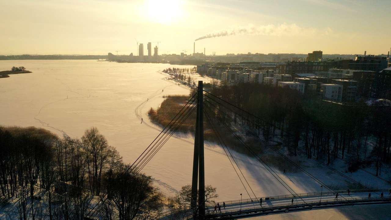 People walk during sunny weather in Helsinki
