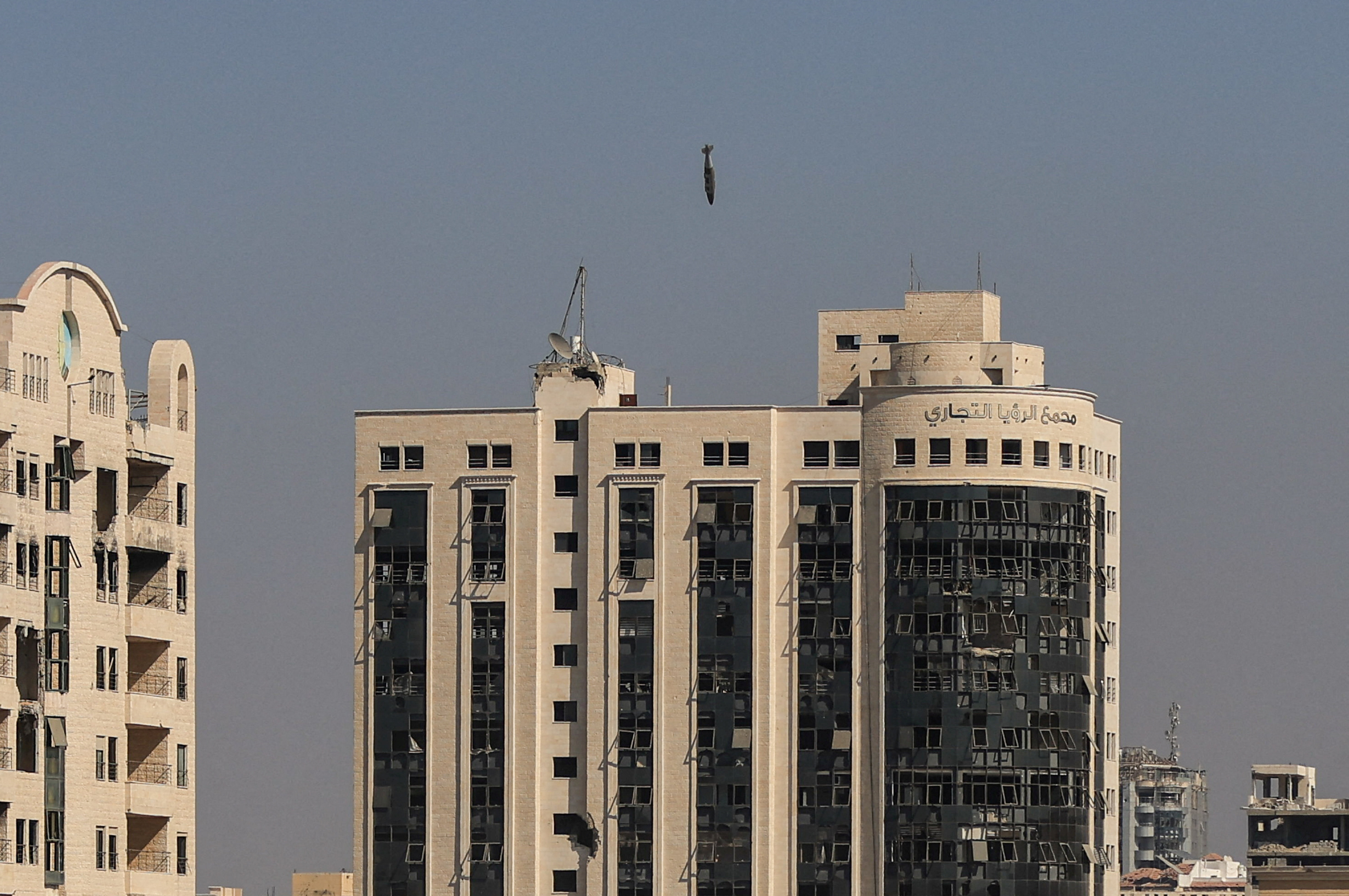 A missile falls towards a building during an Israeli airstrike in Gaza City