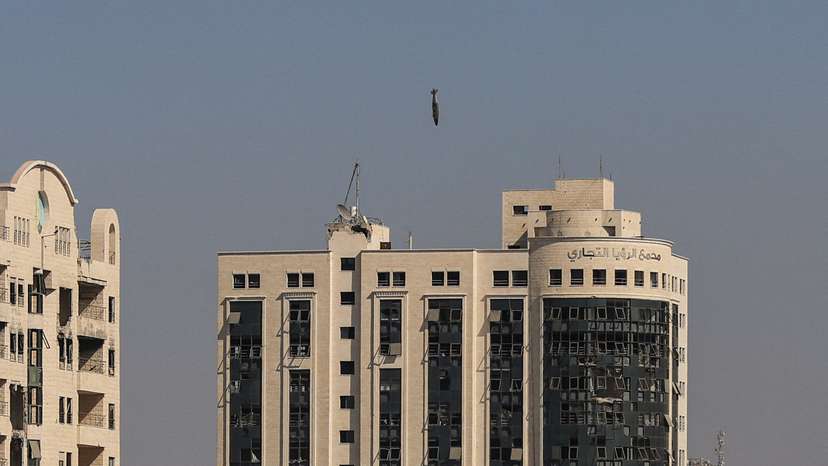 A missile falls towards a building during an Israeli airstrike in Gaza City