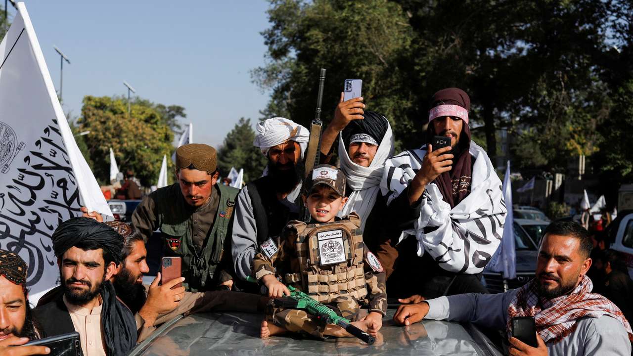 FILE PHOTO: Taliban supporters celebrate on the second anniversary of the fall of Kabul at a street near the U.S. embassy in Kabul