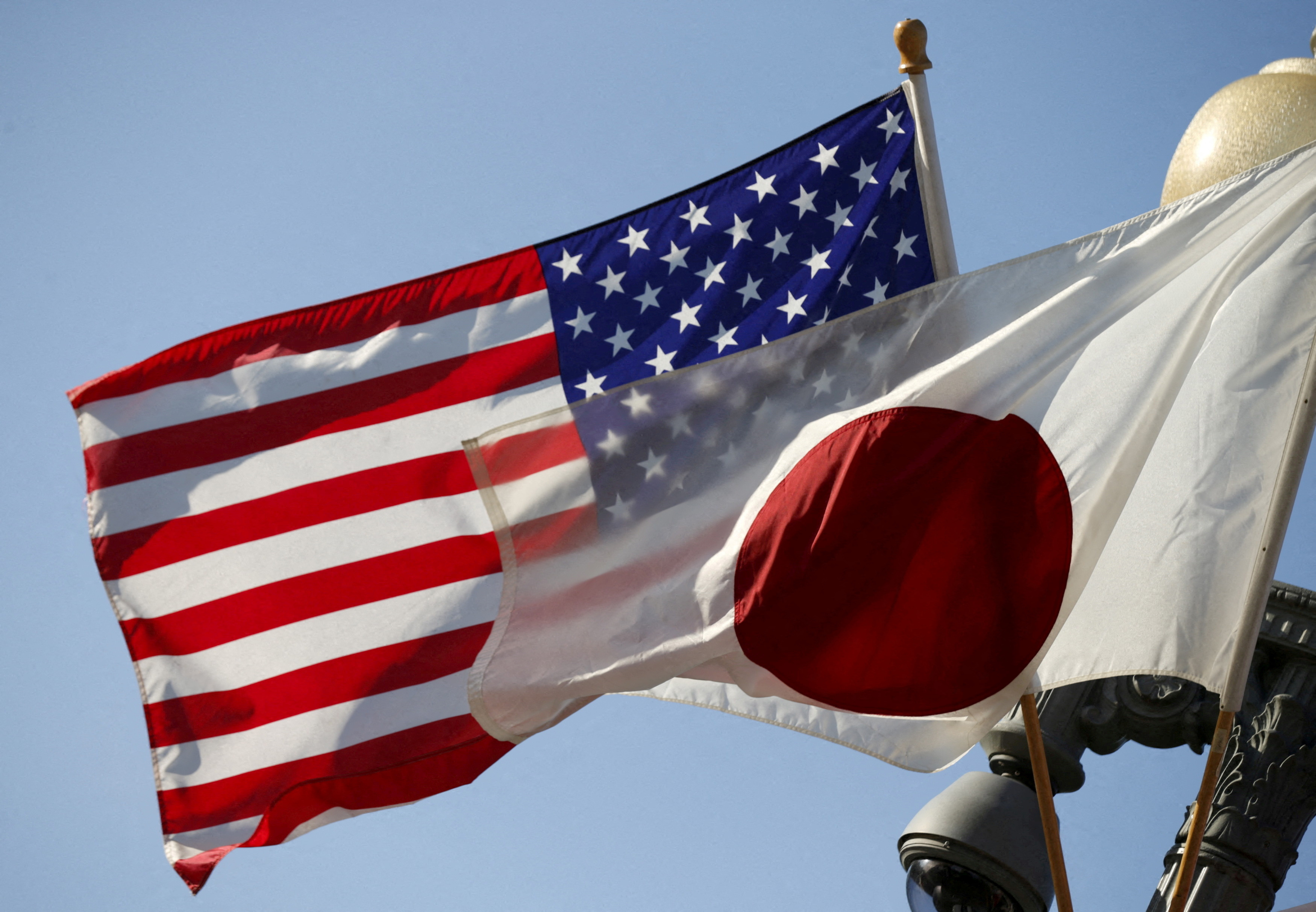 FILE PHOTO: Japan and U.S. flags fly outside the White House in Washington