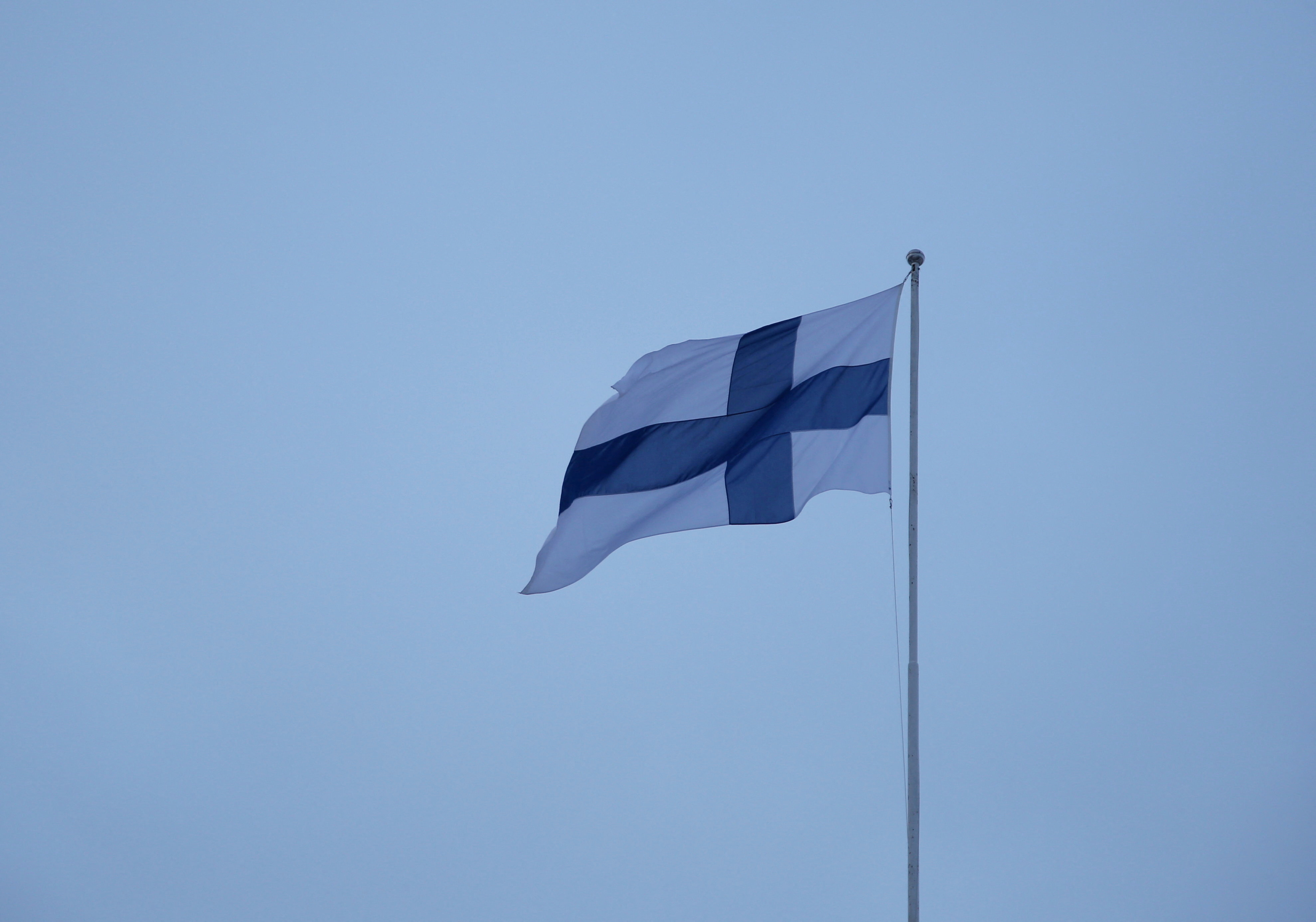 Finnish flag flies over the City Hall in Helsinki