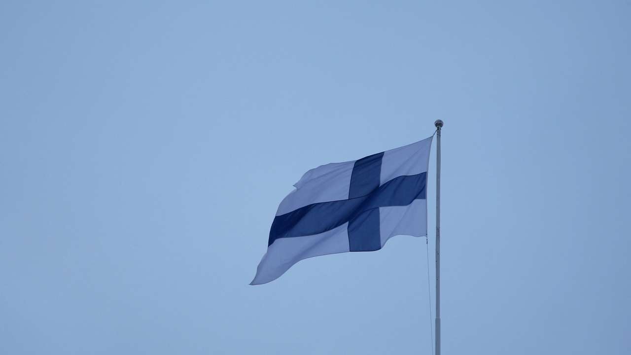 Finnish flag flies over the City Hall in Helsinki