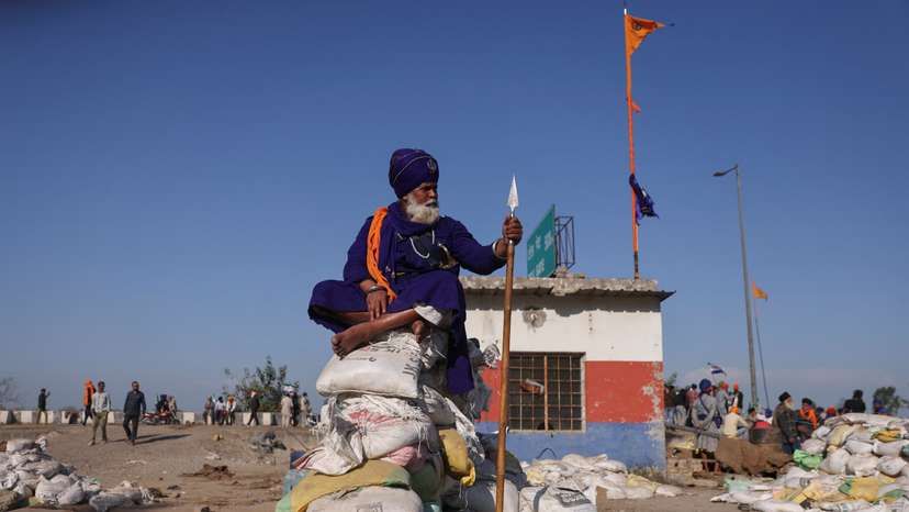 A nihang or Sikh warrior sits on makeshift bunker at a protest site where farmers are marching towards New Delhi to press for the better crop prices promised to them in 2021, at Shambhu Barrier
