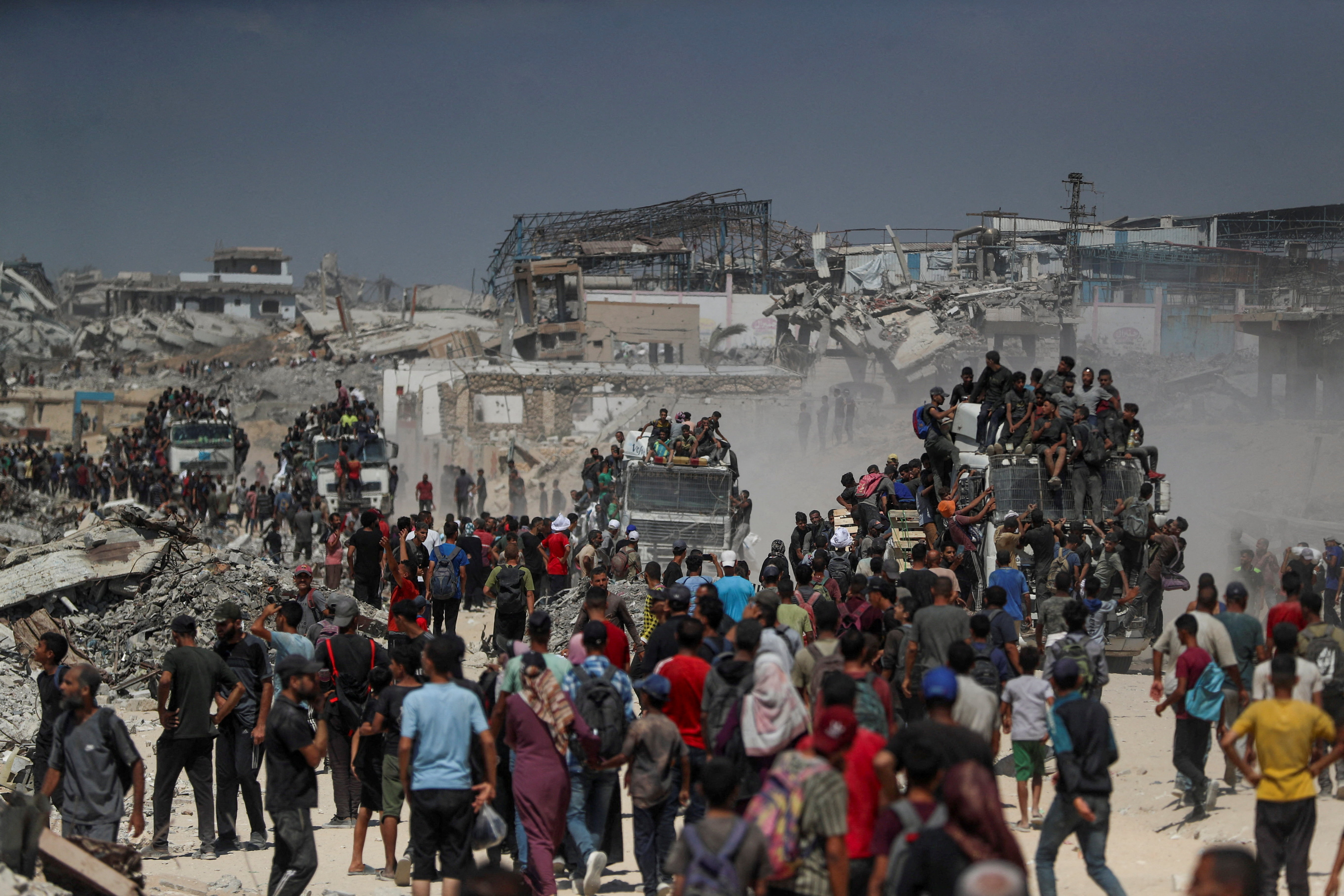Palestinians carry aid supplies that entered Gaza through Israel, in Beit Lahia