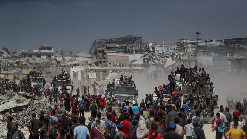 Palestinians carry aid supplies that entered Gaza through Israel, in Beit Lahia