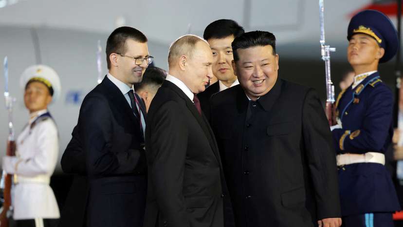 Russian President Vladimir Putin is welcomed by North Korean leader Kim Jong Un upon his arrival at an airport in Pyongyang