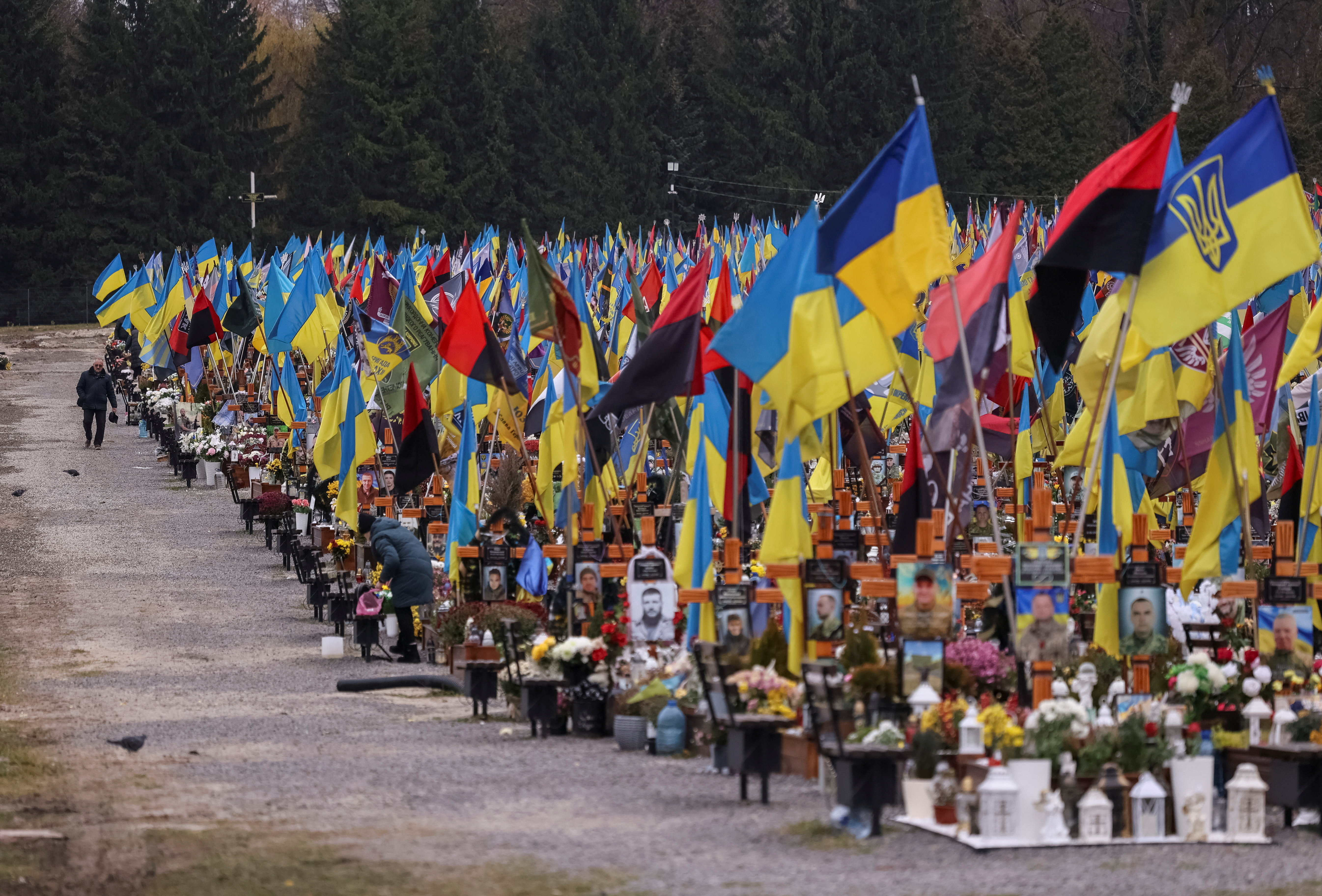 A man visits graves of the killed Ukrainian defenders, at the Lychakiv cemetery in Lviv