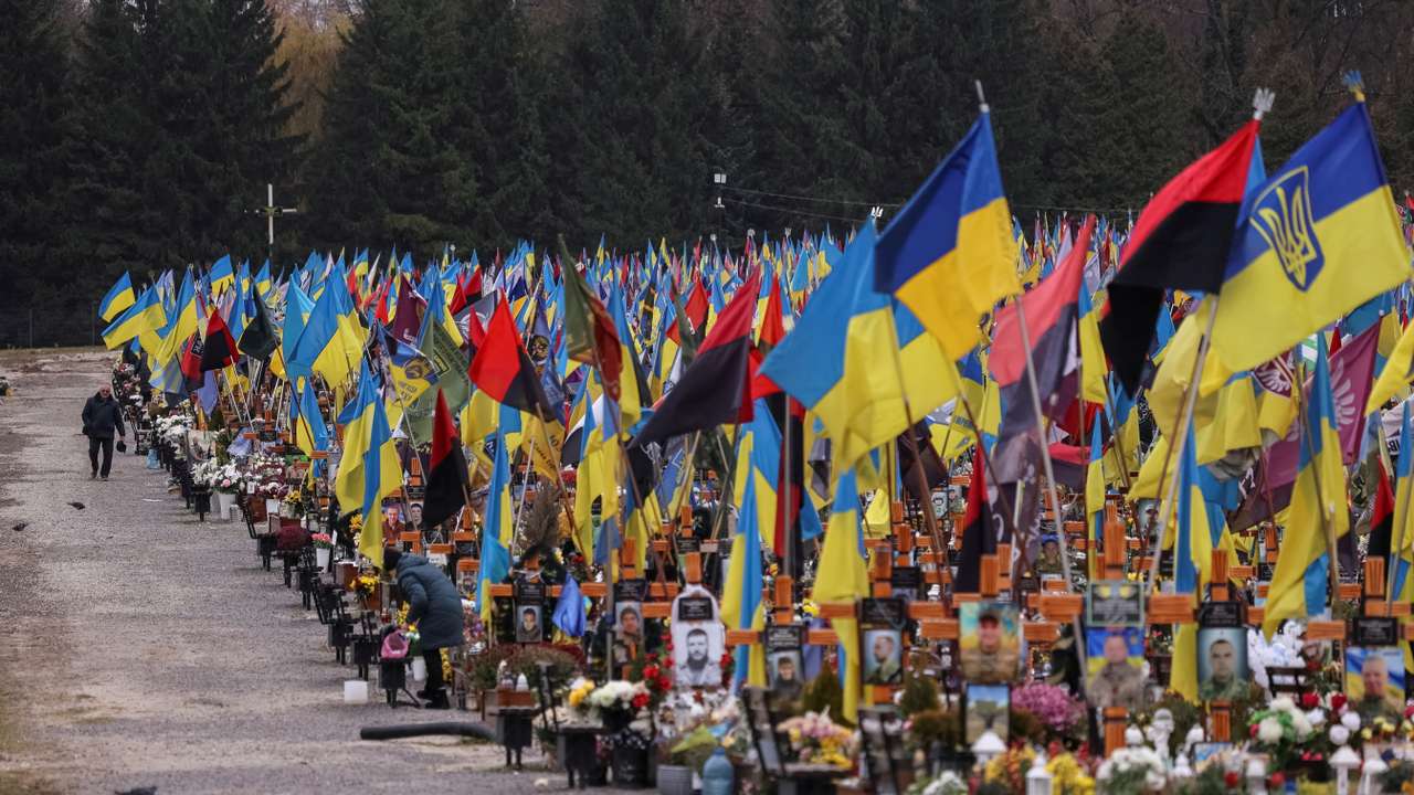 A man visits graves of the killed Ukrainian defenders, at the Lychakiv cemetery in Lviv