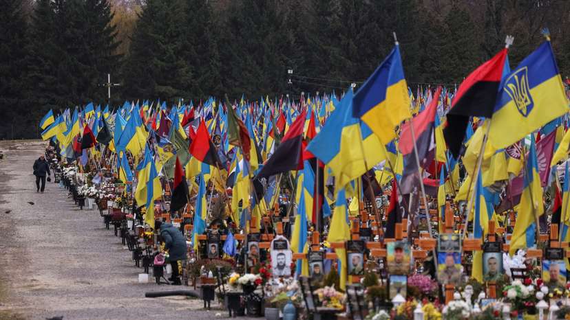 A man visits graves of the killed Ukrainian defenders, at the Lychakiv cemetery in Lviv