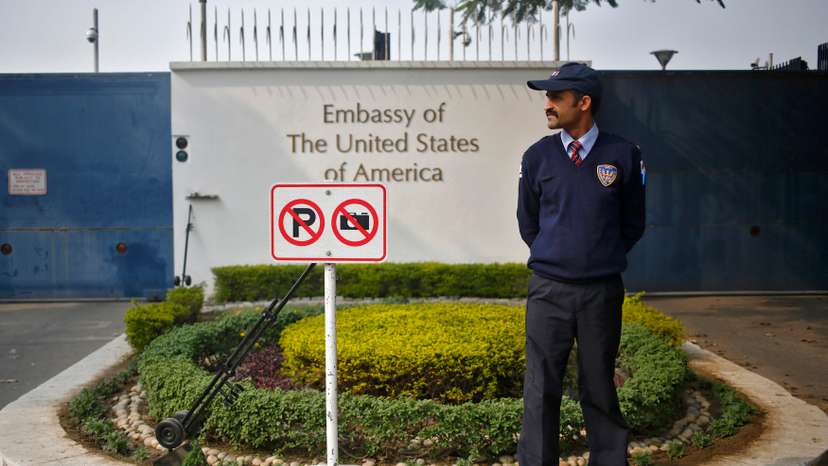 A private security guard stands outside the U.S. embassy in New Delhi