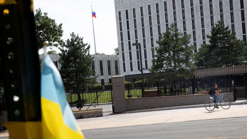 A pedestrian rides a bicycle outside the Russian Embassy in the Glover Park neighborhood in Washington