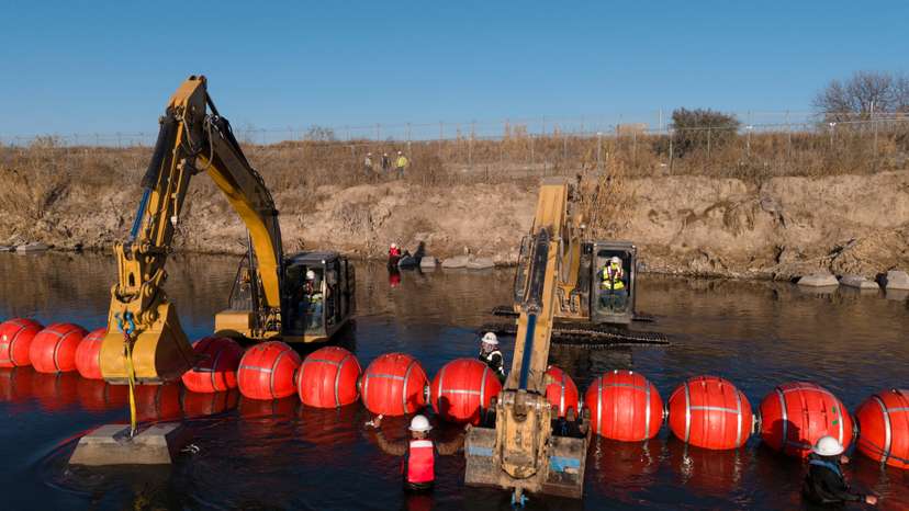 Workers assemle buoys at the U.S. Mexico border in Eagle Pass, Texas