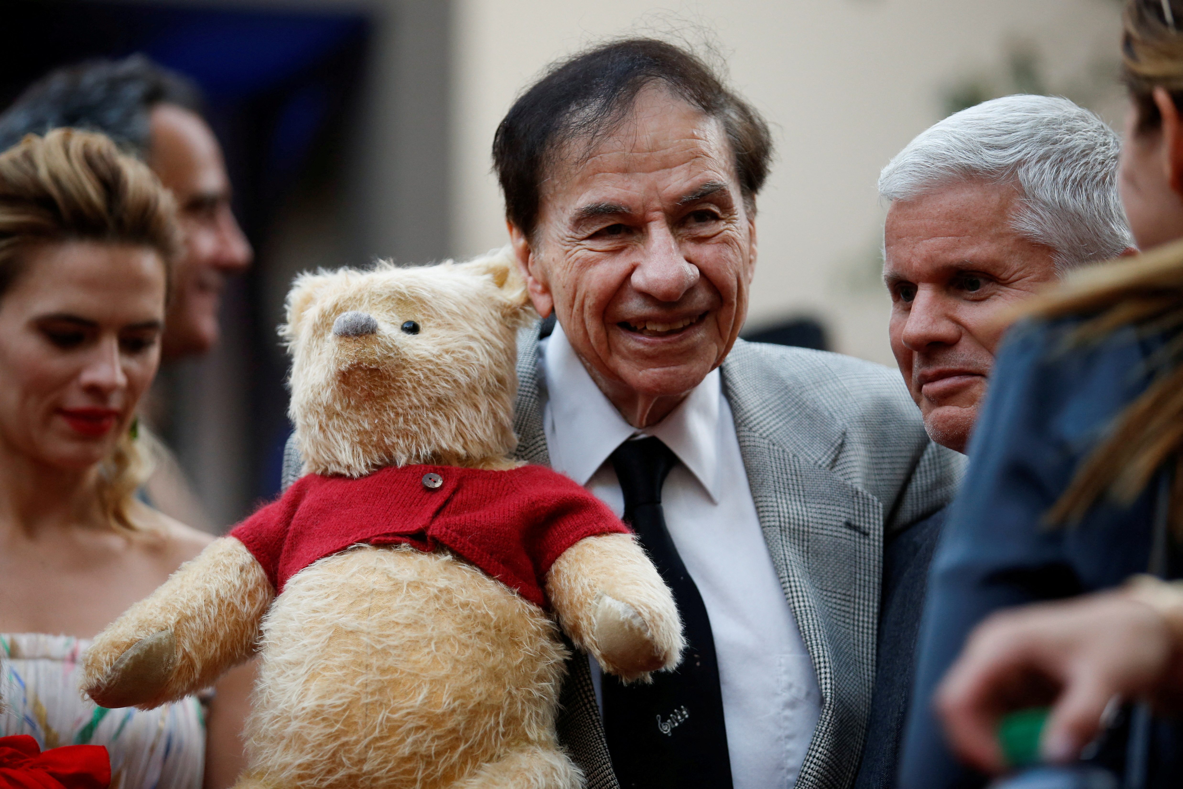 FILE PHOTO: Songwriter Richard M. Sherman holds a stuffed Winnie the Pooh as he poses at the world premiere of Disney's "Christopher Robin," in Burbank