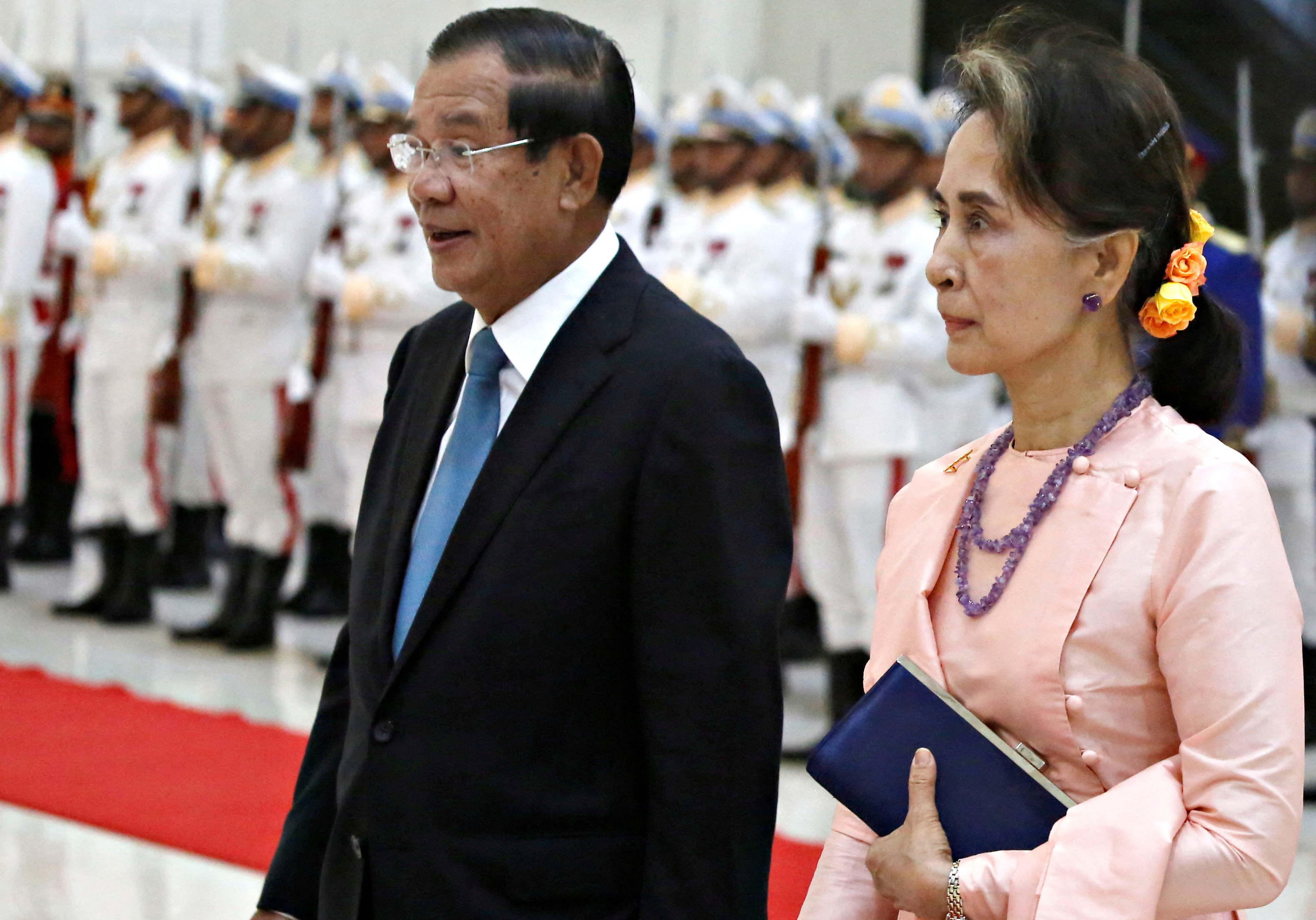 FILE PHOTO: Myanmar's State Counsellor Aung San Suu Kyi is welcomed by Cambodia's Prime Minister Hun Sen at the Peace Palace in Phnom Penh