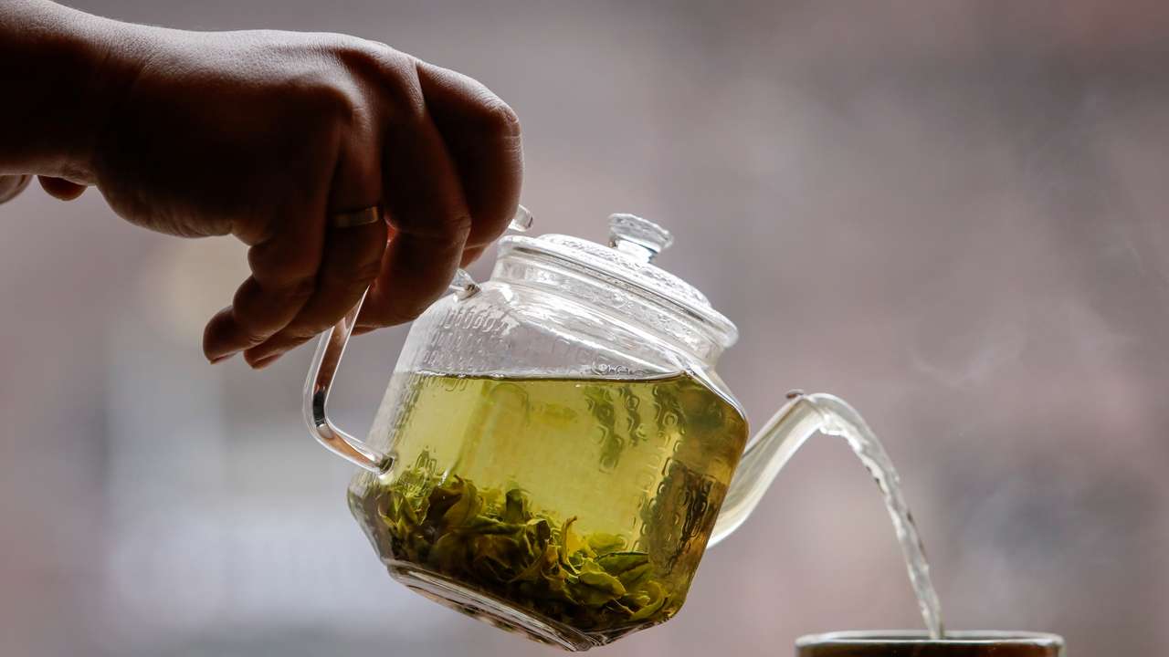 The owner of a tea house pours a cup of tea in this picture illustration