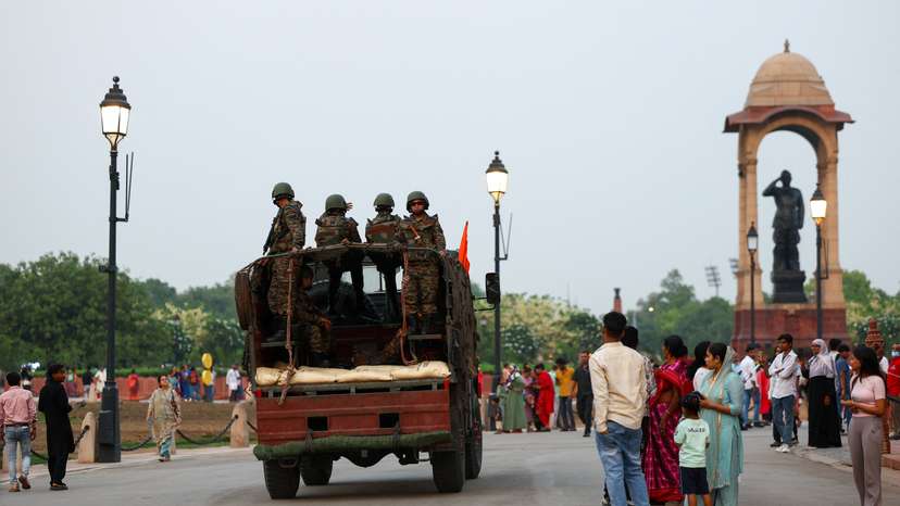 Military personnel with Indian Army stand guard at India Gate in New Delhi