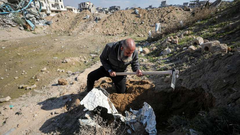 Palestinians search for bodies and graves of loved ones following a ceasefire, in Gaza City