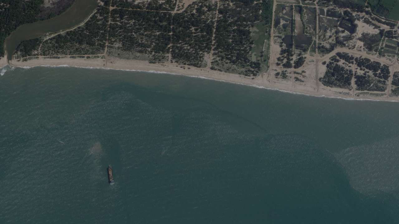 FILE PHOTO: A satellite image taken by Planet Labs shows deck cargo ships, loaded with vehicles, cruising towards the beach near Jiesheng, Guangdong