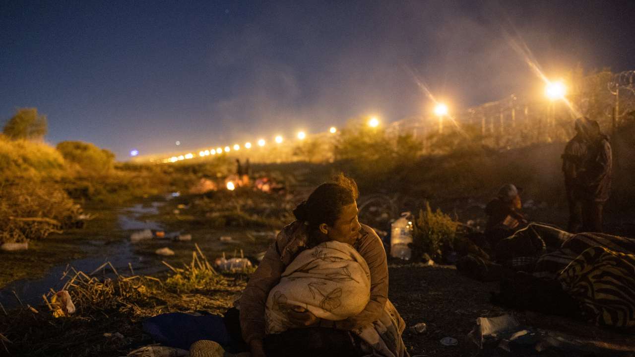 Migrant woman from Nicaragua looks towards the U.S. from the riverbed of the Rio Grande