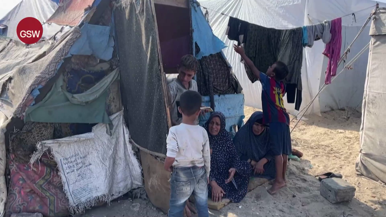 Women and children outside a tent in Deir el-Balah, a Palestinian city in the central Gaza Strip