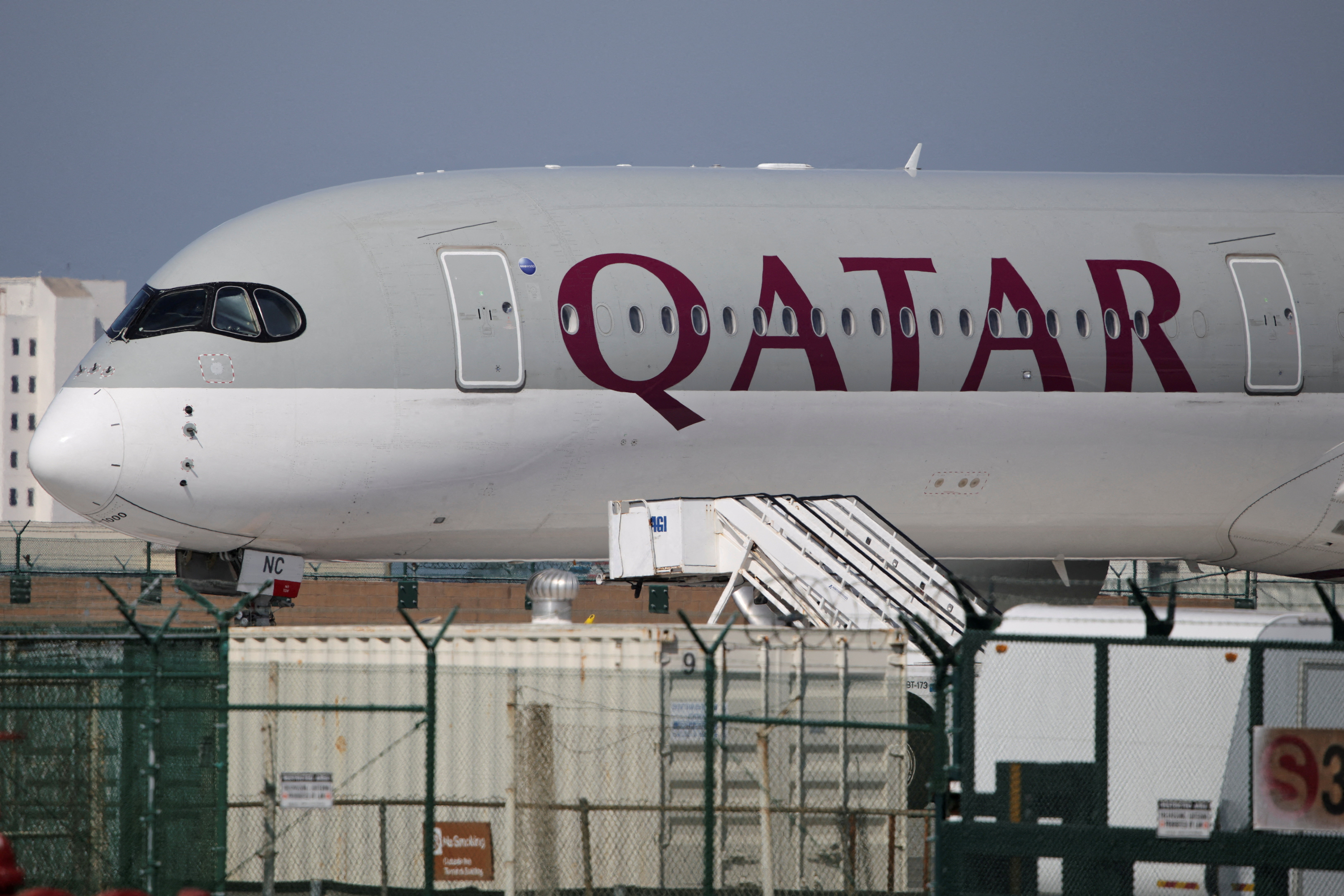 FILE PHOTO: A Qatar Airways plane sits on the tarmac at Los Angeles International Airport (LAX)