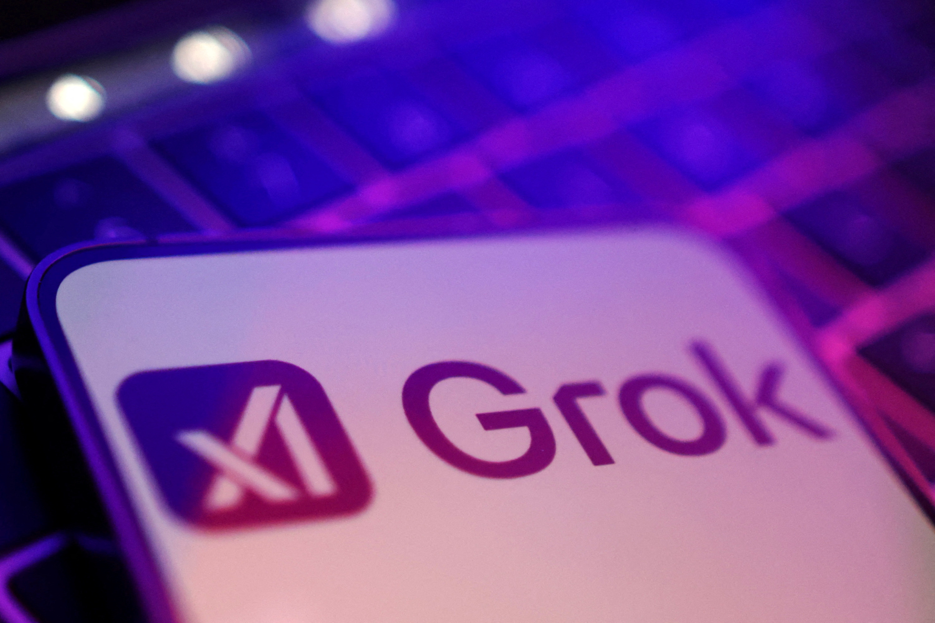 FILE PHOTO: Illustration shows xAI and Grok logos