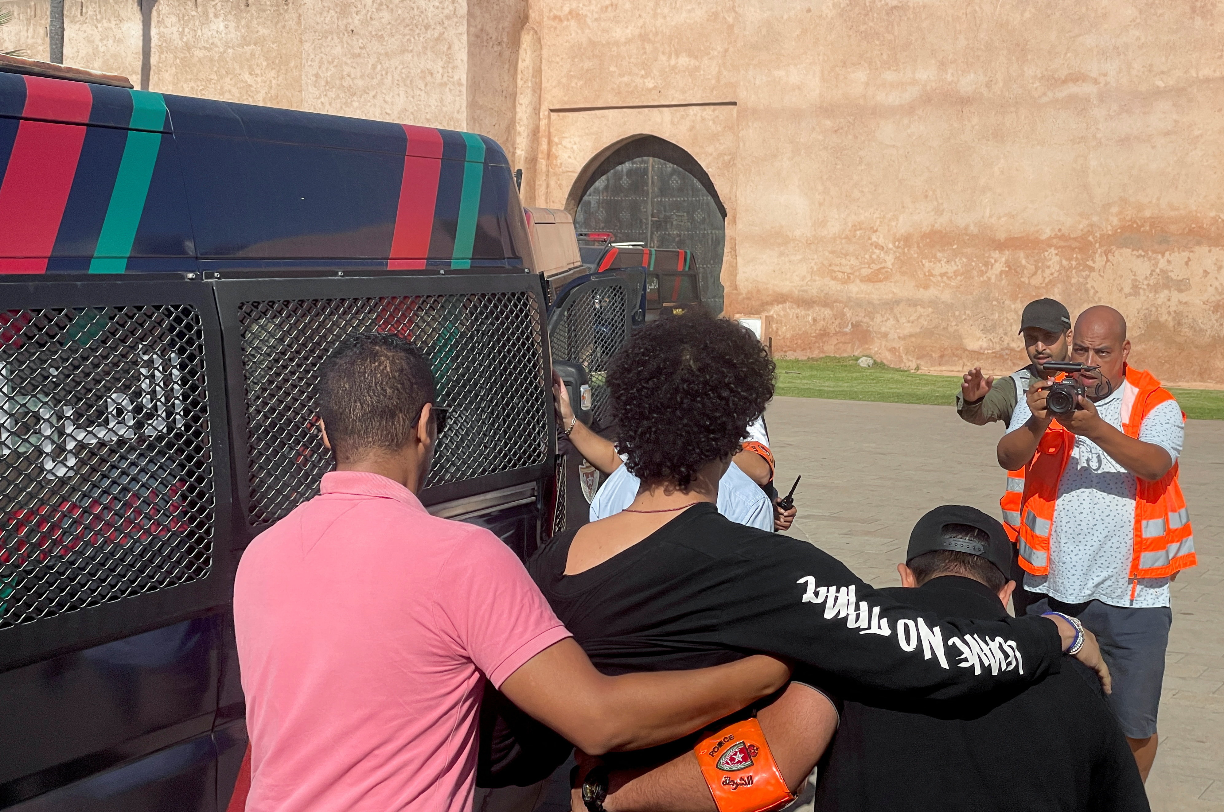 Police officers detain a young man who wanted to protest for better healthcare and education services, in Rabat