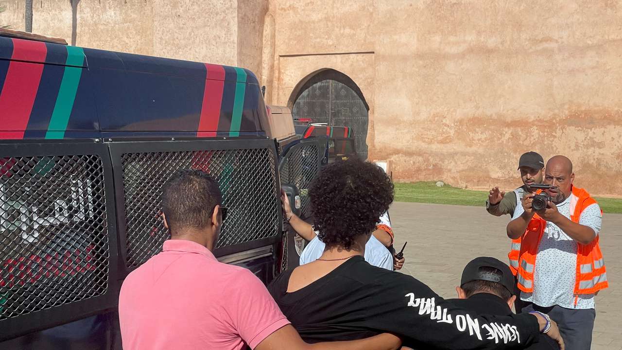 Police officers detain a young man who wanted to protest for better healthcare and education services, in Rabat