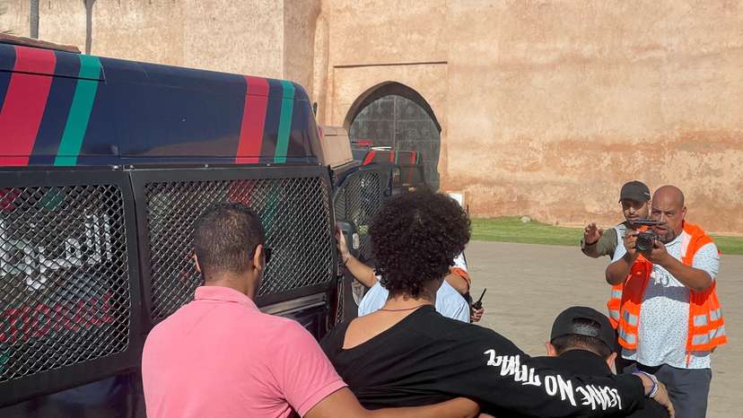 Police officers detain a young man who wanted to protest for better healthcare and education services, in Rabat