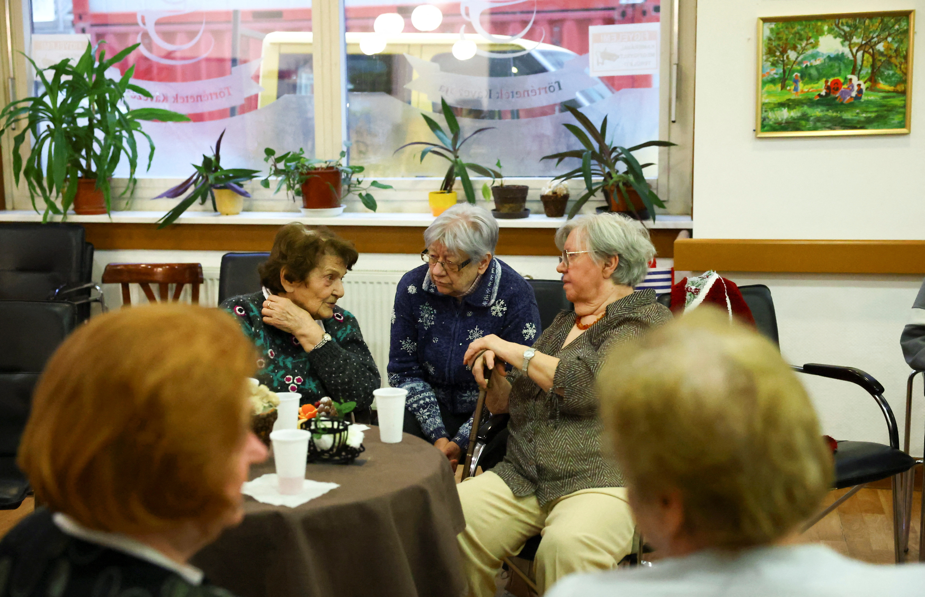 Elderly women talk in a pensioners club in Budapest