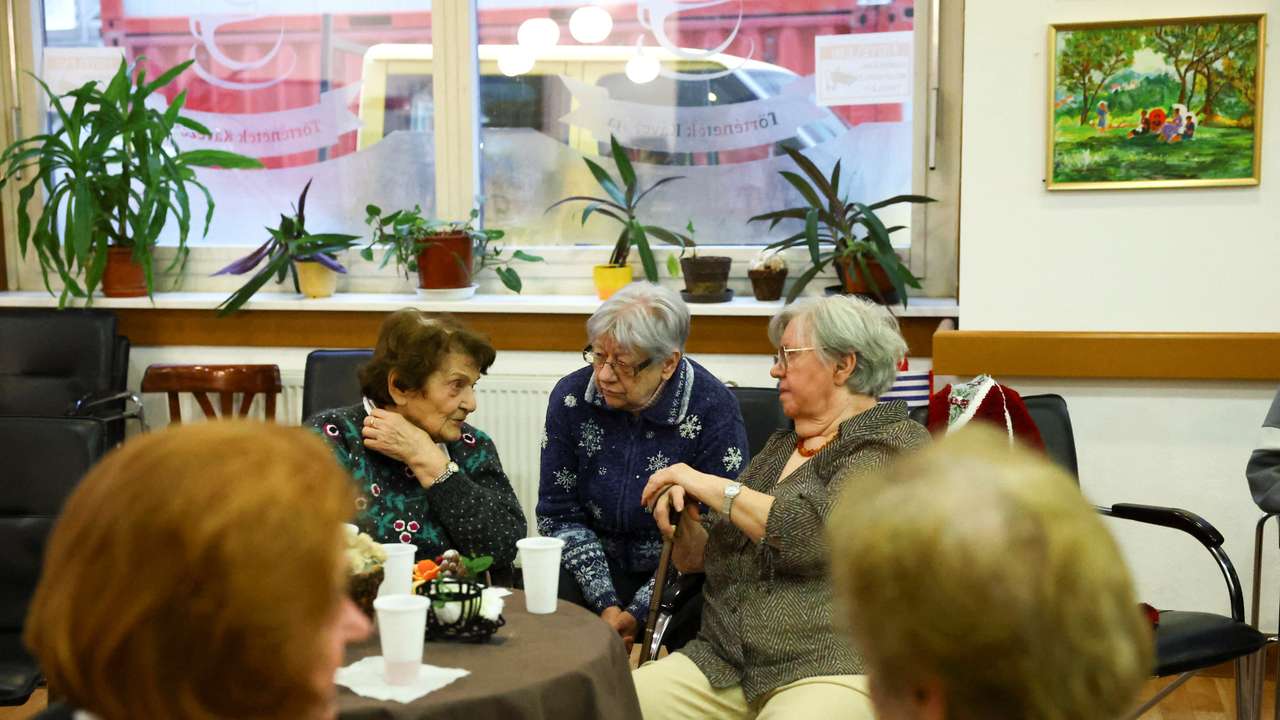 Elderly women talk in a pensioners club in Budapest