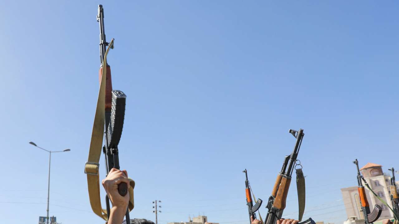 Newly recruited Houthi fighters shout slogans during a ceremony at the end of their training in Sanaa