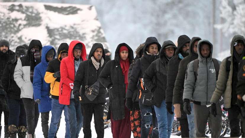 FILE PHOTO: Group of migrants arrive to the international border crossing at Salla