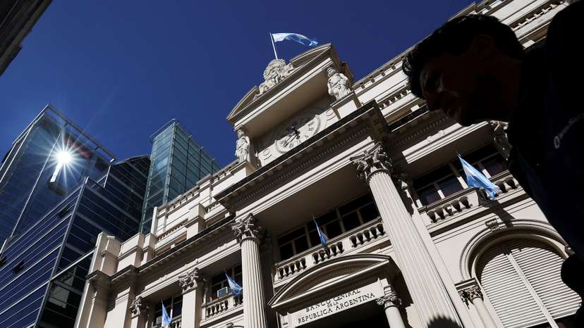 A man walks past the facade of Argentina’s Central Bank, one day after the inauguration of Argentina's President Javier Milei, in Buenos Aires