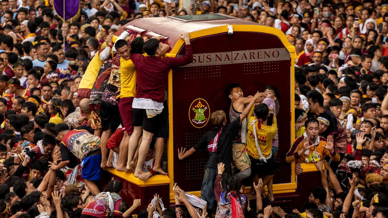 Filipino Catholic devotees parade "Black Nazarene" in celebration of Christ