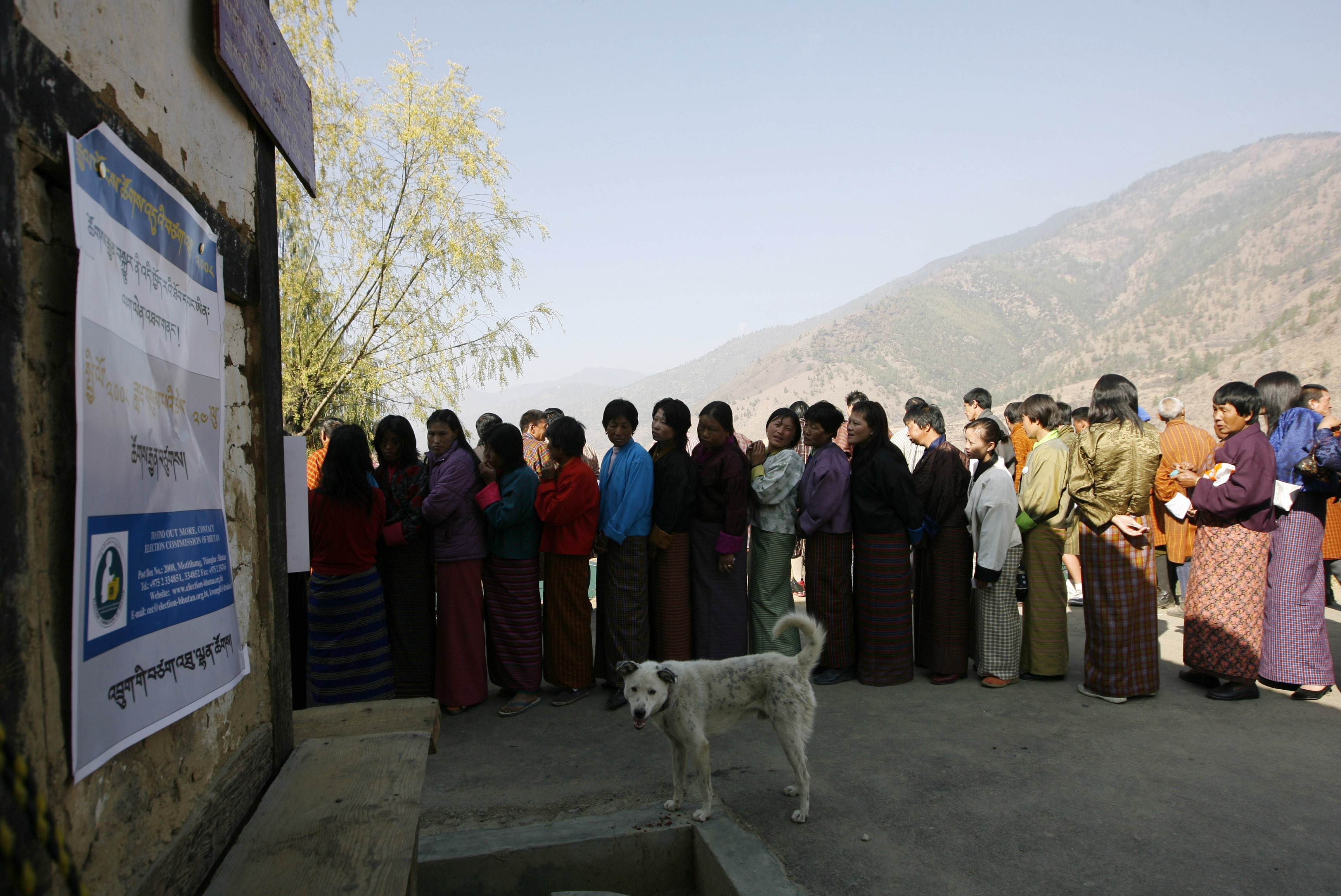 FILE PHOTO: Bhutanese voters stand in a queue outside a polling station to cast their ballot in Thimpu