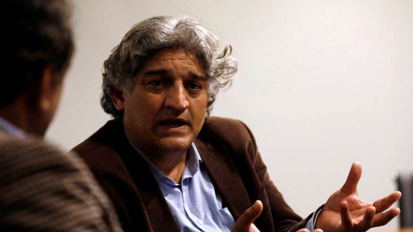 FILE PHOTO: Matiullah Jan, a journalist and columnist, gestures during an interview with Reuters at his office in Islamabad
