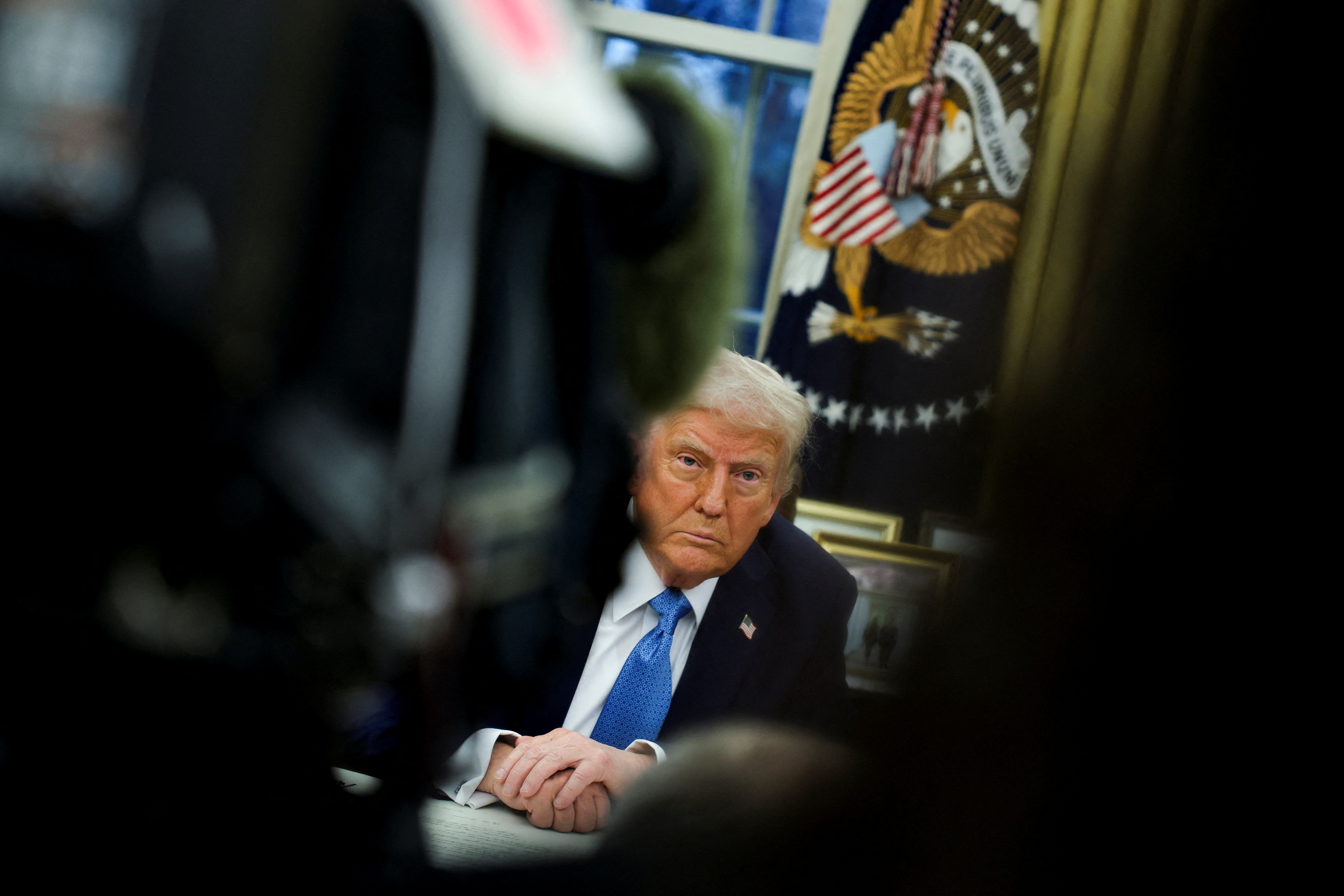 U.S. President Donald Trump signs an executive order in the Oval Office at the White House