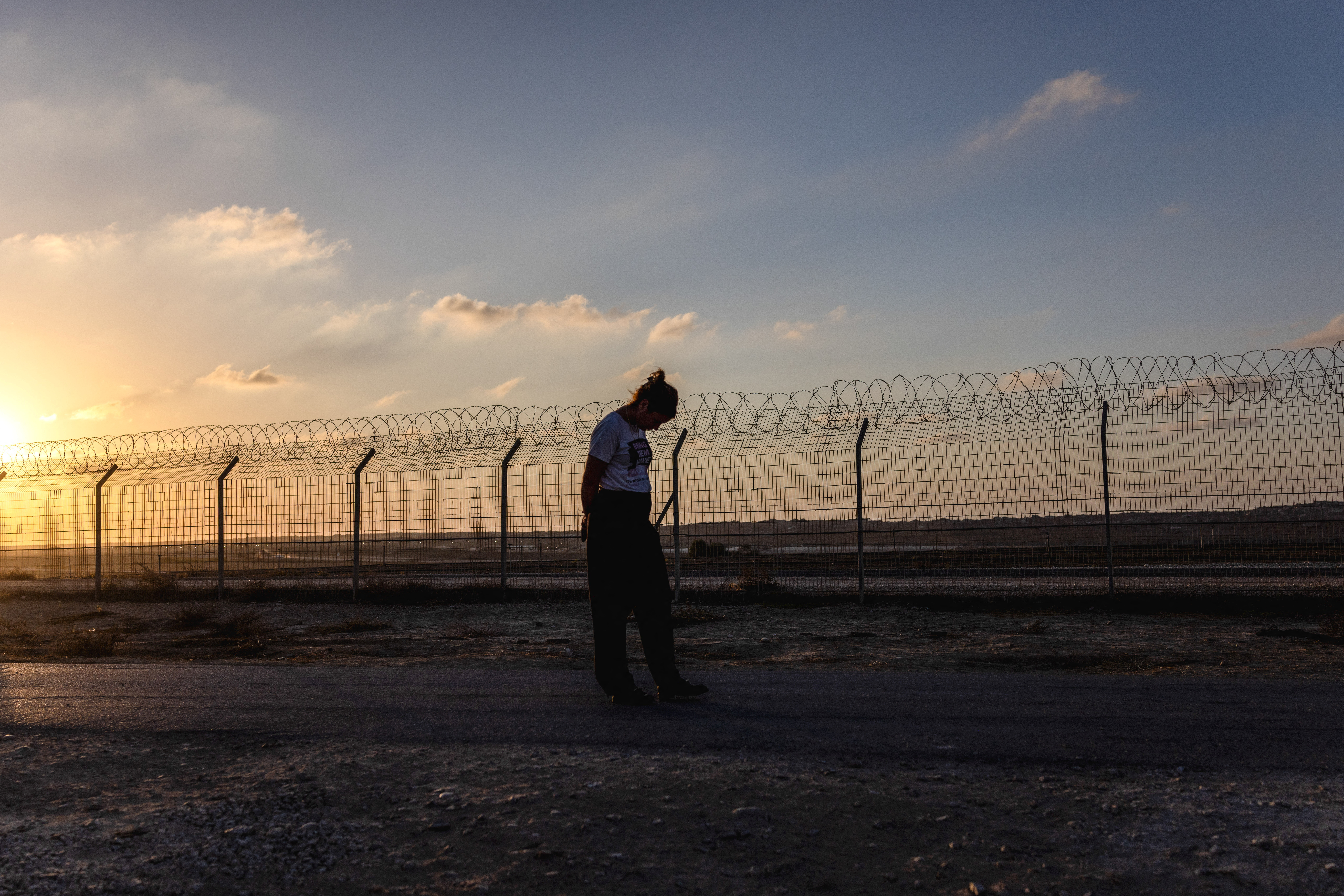 Kibbutz member Yael Raz Lachyani, 49, walks by the fence of Kibbutz Nahal Oz in southern Israel