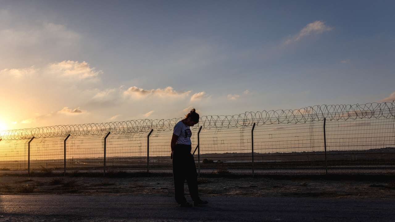 Kibbutz member Yael Raz Lachyani, 49, walks by the fence of Kibbutz Nahal Oz in southern Israel