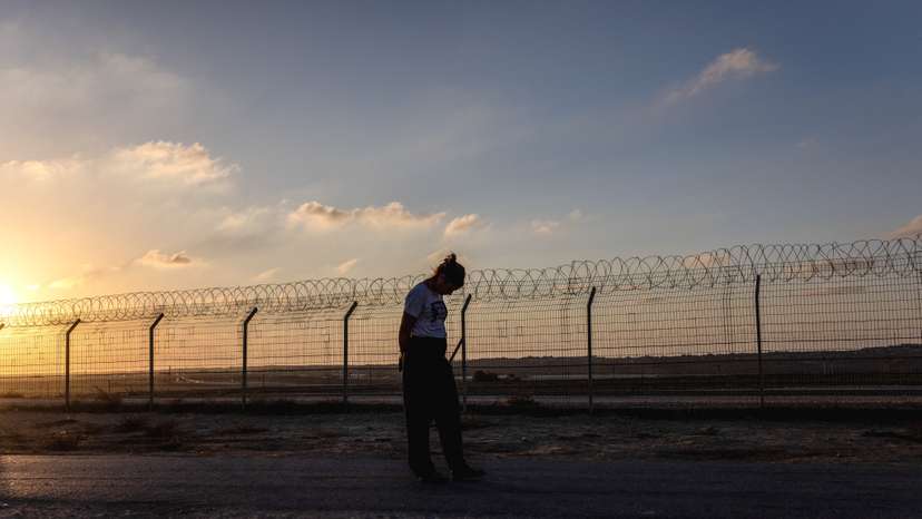 Kibbutz member Yael Raz Lachyani, 49, walks by the fence of Kibbutz Nahal Oz in southern Israel