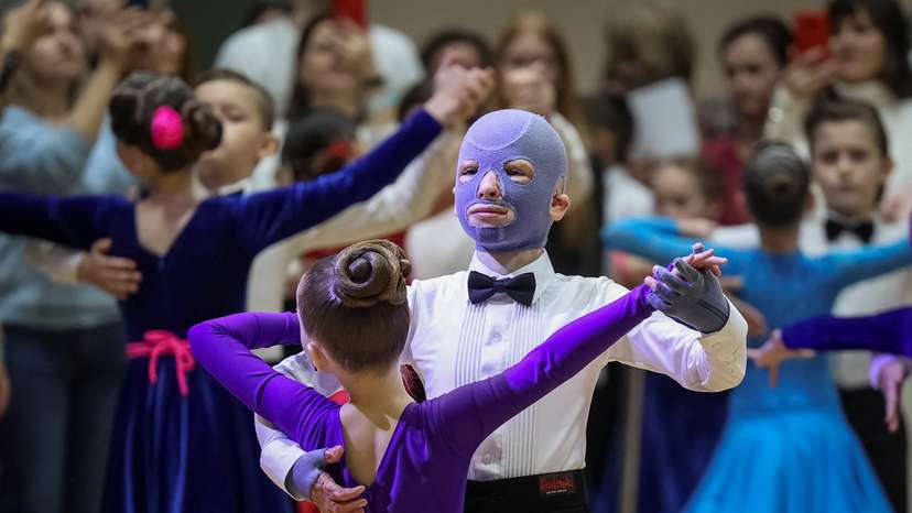 Roman, wounded by Russian missile strike last year, wears a burn mask as he takes part in a ballroom dance competition, in Lviv