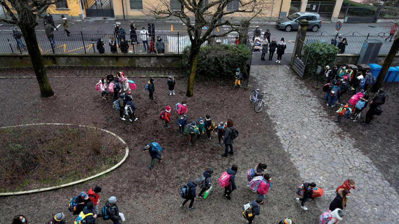 FILE PHOTO: Primary schoolchildren stand in groups in a school courtyard in Lombardy