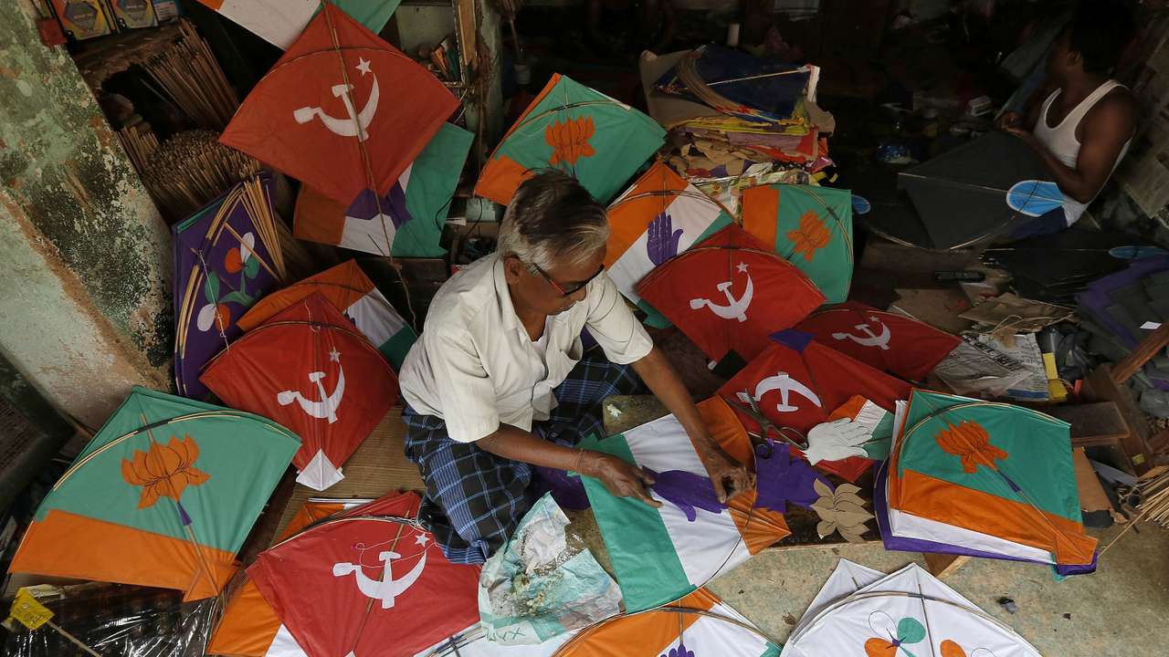 A kite-maker prepares kites with election symbols of Indian political parties at his shop ahead of India's general election